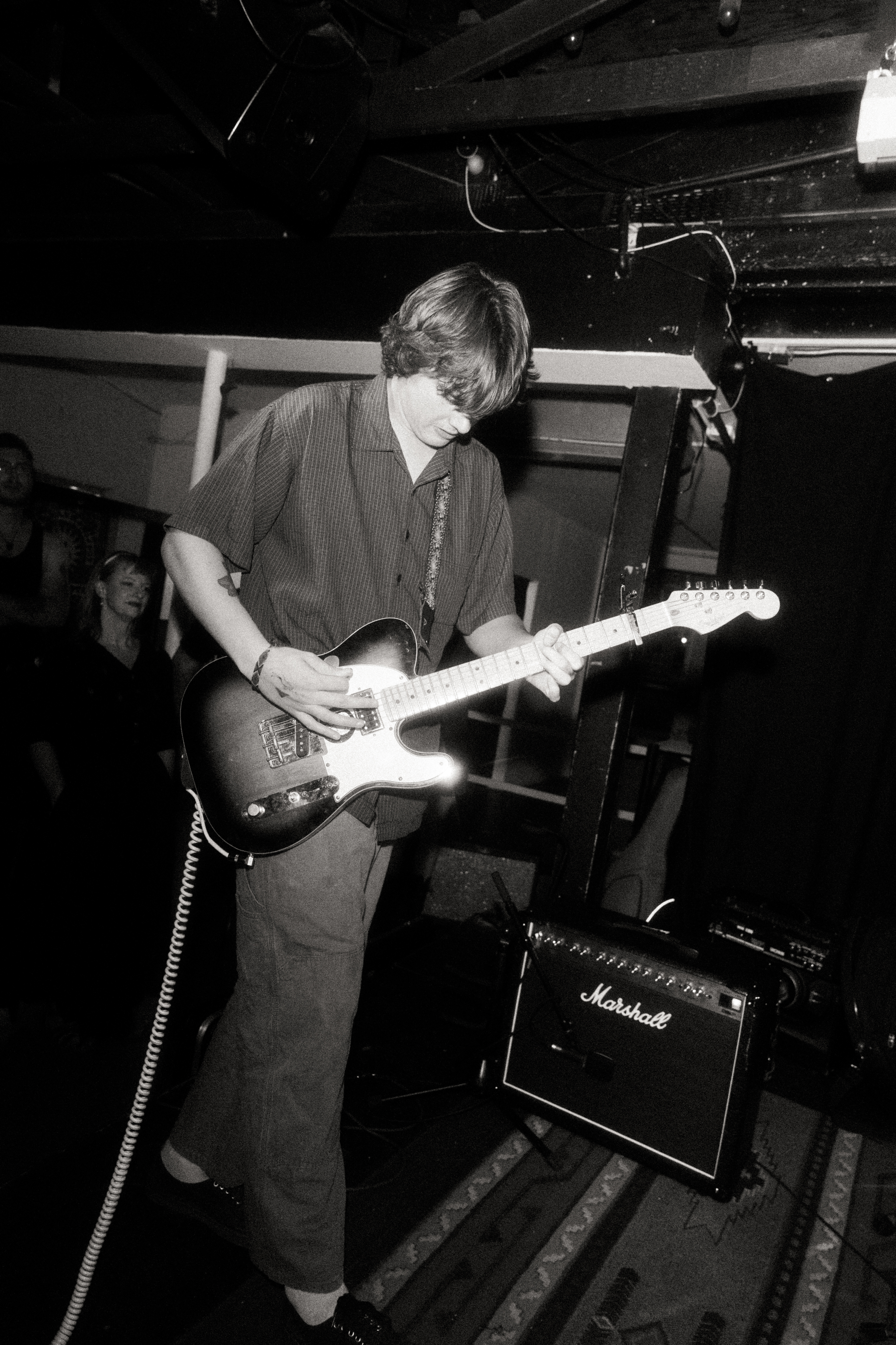 Etiquette guitarist in a live portrait shot